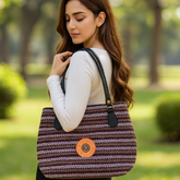 Brown Striped Jute Handbag with Black Handles and Orange Patch
