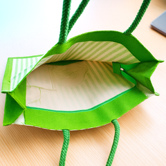 Green Striped Jute Tote Bag with Artistic Face Design